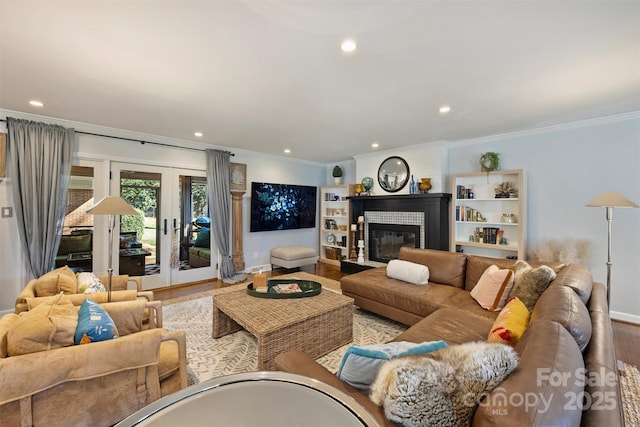 living room featuring crown molding and light hardwood / wood-style flooring