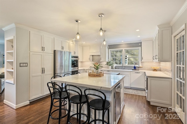 kitchen with hanging light fixtures, white cabinetry, and a center island