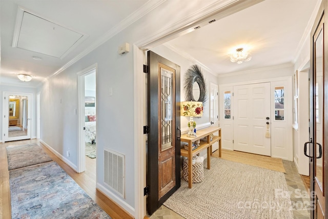 entrance foyer featuring light hardwood / wood-style flooring and ornamental molding