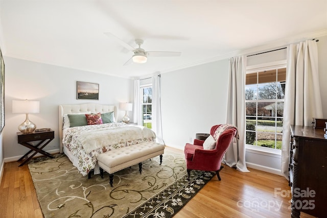 bedroom featuring ceiling fan, ornamental molding, and hardwood / wood-style flooring