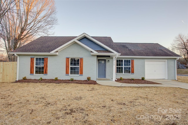 view of front of home with a front lawn and a garage