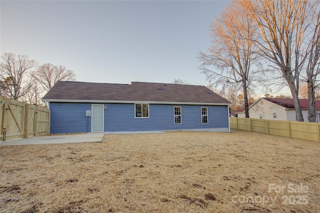 rear view of property featuring a yard and a patio