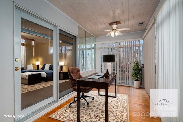 home office featuring ceiling fan, wood-type flooring, ornamental molding, and wooden ceiling