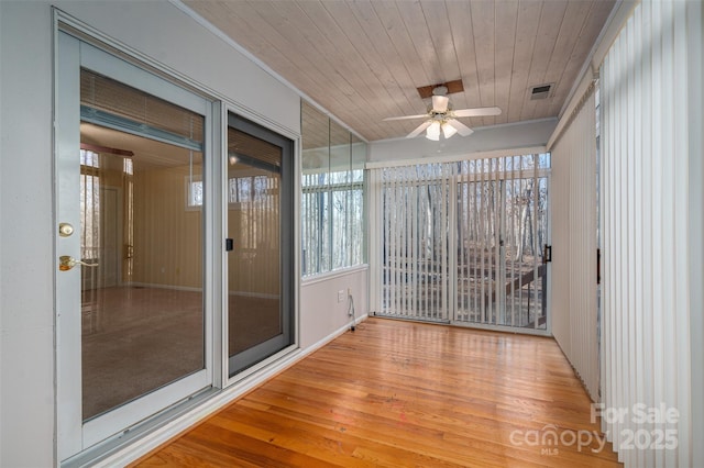 unfurnished sunroom with wood ceiling and ceiling fan