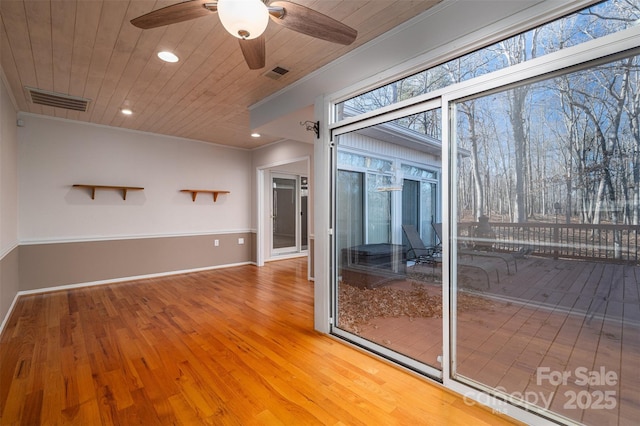 interior space featuring wood ceiling, crown molding, and hardwood / wood-style floors