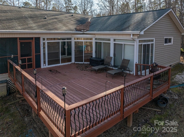 wooden deck featuring a sunroom