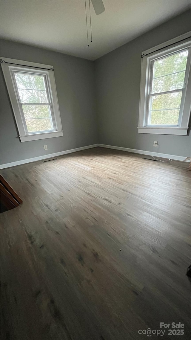 spare room with hardwood / wood-style floors and ceiling fan