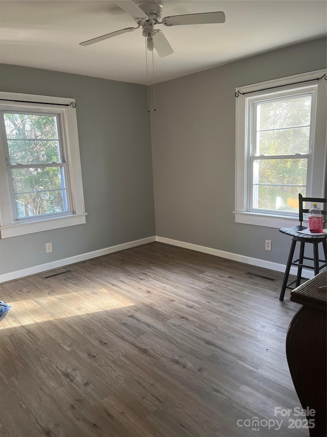 empty room featuring hardwood / wood-style flooring and ceiling fan