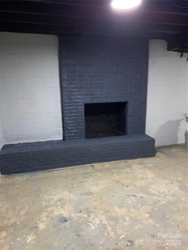 interior space with concrete flooring and a fireplace