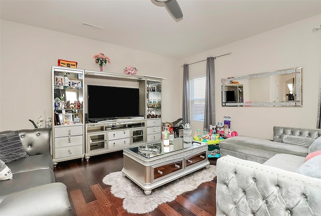 living room with dark wood-type flooring and ceiling fan