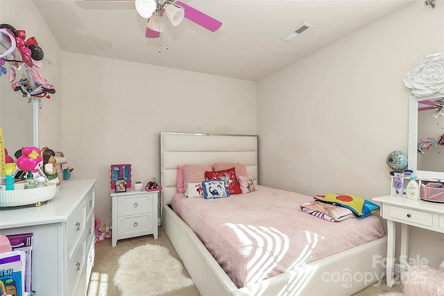 bedroom with ceiling fan and light carpet