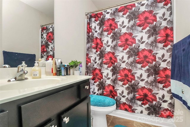 bathroom featuring toilet, vanity, and tile patterned flooring