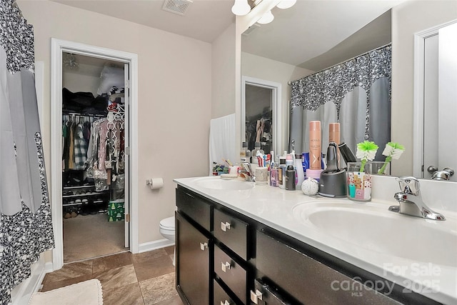 bathroom with toilet and vanity