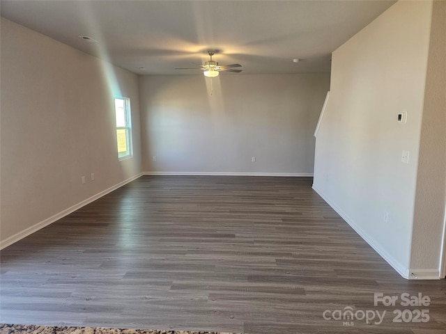 empty room featuring ceiling fan and dark hardwood / wood-style floors