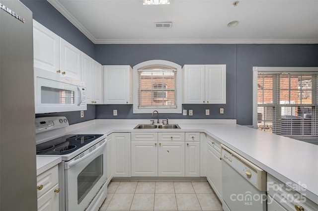 kitchen with sink, white appliances, white cabinetry, and light tile patterned flooring