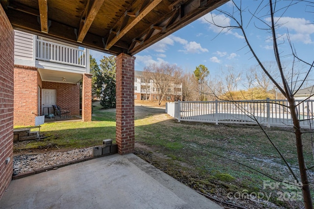 view of yard with a patio area and a balcony