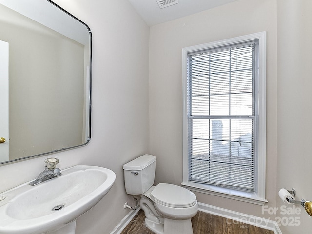 bathroom with hardwood / wood-style flooring, sink, and toilet