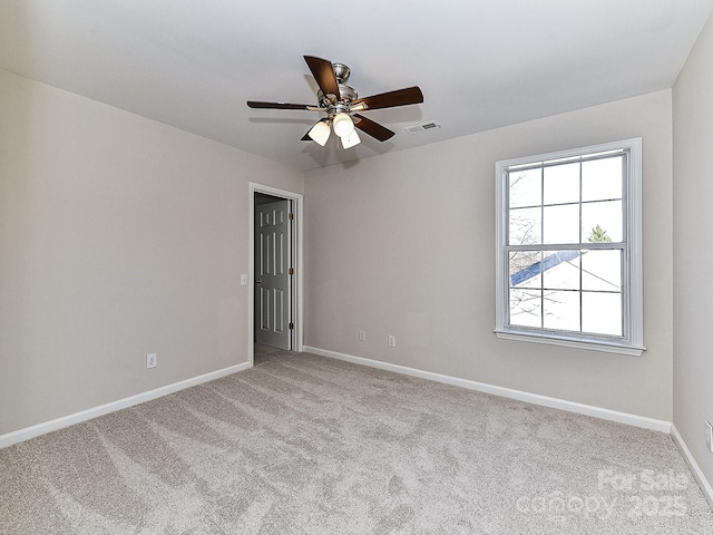 empty room with ceiling fan and light colored carpet