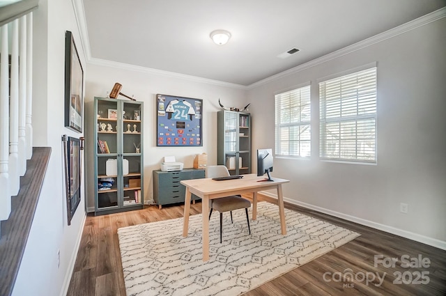 home office featuring baseboards, wood finished floors, visible vents, and ornamental molding