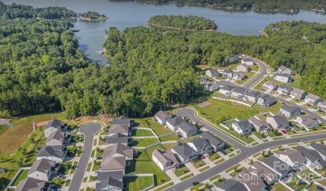 aerial view with a wooded view, a water view, and a residential view