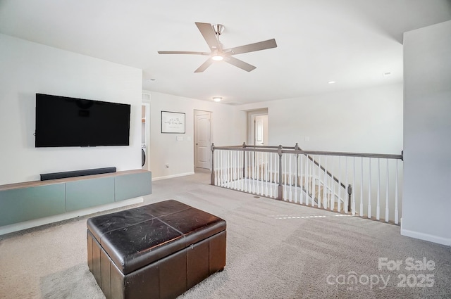 carpeted living room with ceiling fan