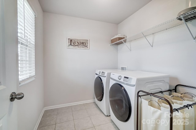 laundry room with light tile patterned floors, baseboards, laundry area, and washer and clothes dryer