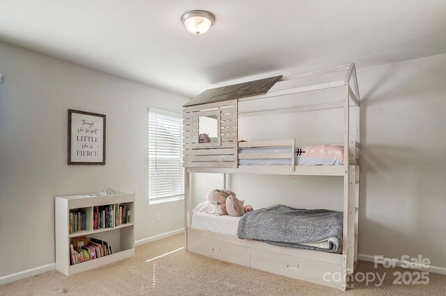 bedroom featuring baseboards and carpet