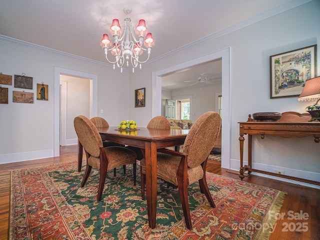 dining room featuring wood-type flooring, crown molding, and an inviting chandelier