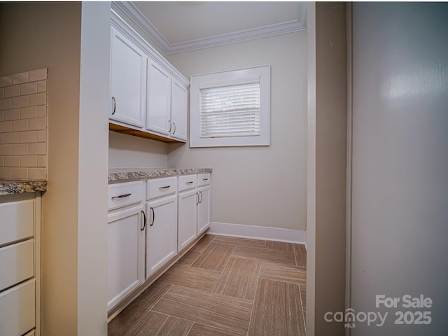 clothes washing area with ornamental molding