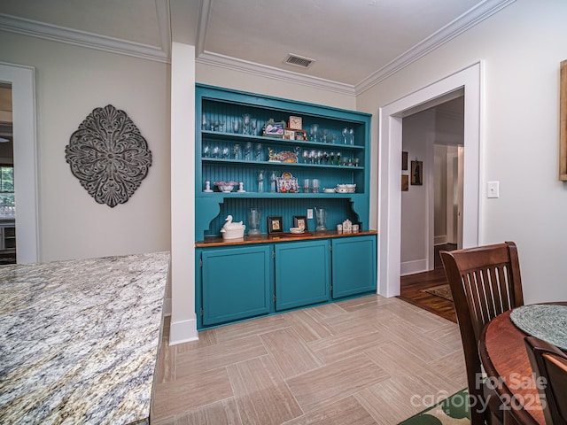 bar featuring light stone countertops, built in features, ornamental molding, and blue cabinets