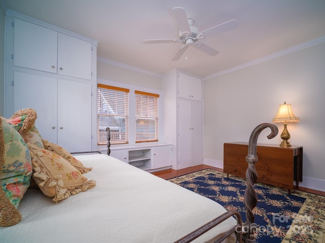 bedroom with ceiling fan, hardwood / wood-style floors, a closet, and ornamental molding