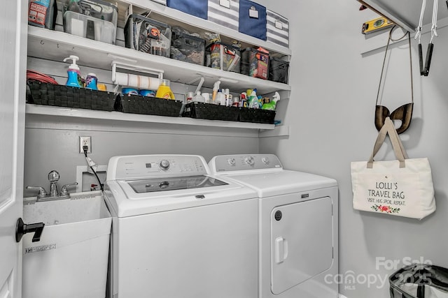 washroom featuring washing machine and dryer and sink