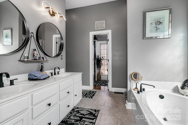 bathroom featuring vanity, tile patterned flooring, and a tub