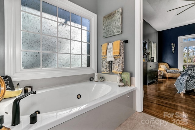 bathroom with a bath and tile patterned floors