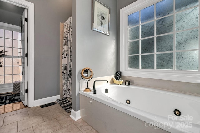 bathroom with a bath and tile patterned floors