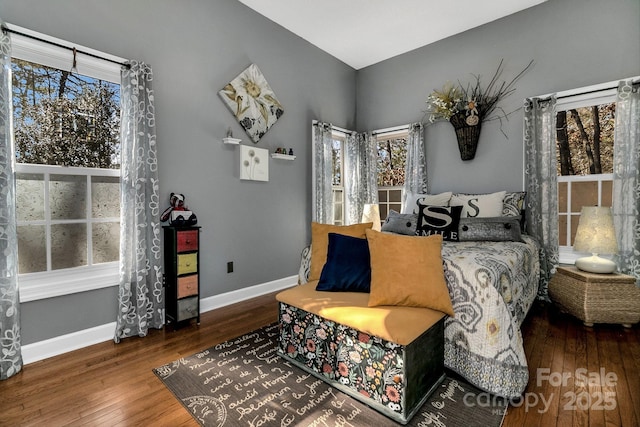 bedroom with hardwood / wood-style floors and multiple windows