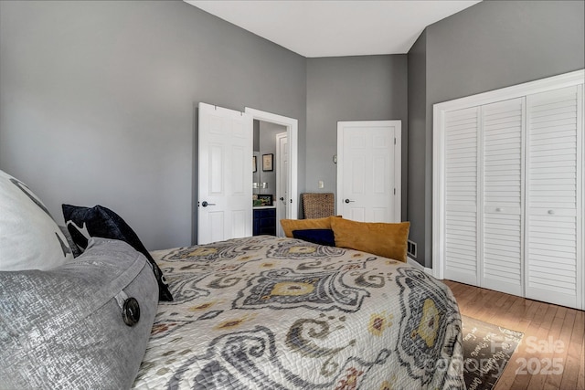 bedroom featuring hardwood / wood-style floors and a closet