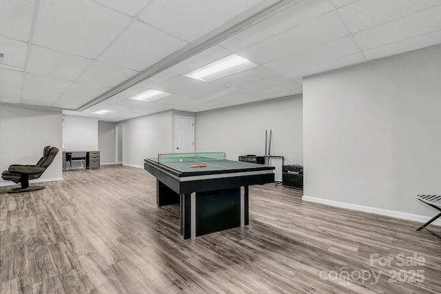 rec room with hardwood / wood-style flooring and a drop ceiling