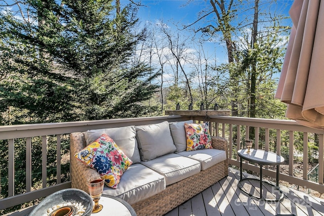 wooden terrace with an outdoor living space