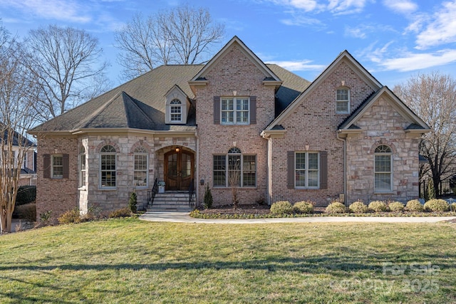 view of front of home with french doors and a front lawn