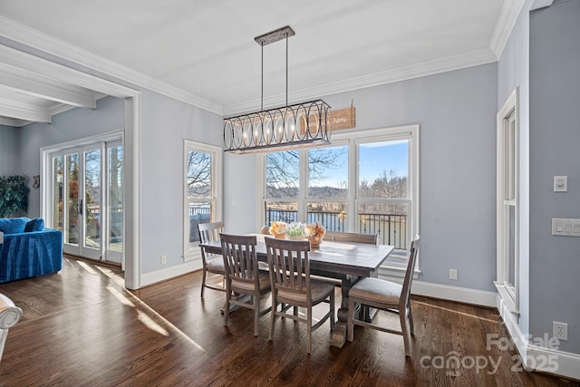 dining area with crown molding, dark hardwood / wood-style floors, and an inviting chandelier