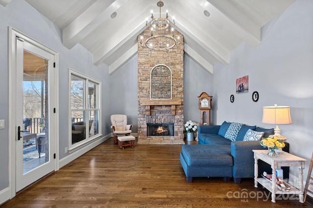 living room featuring a stone fireplace, dark hardwood / wood-style floors, an inviting chandelier, high vaulted ceiling, and beam ceiling