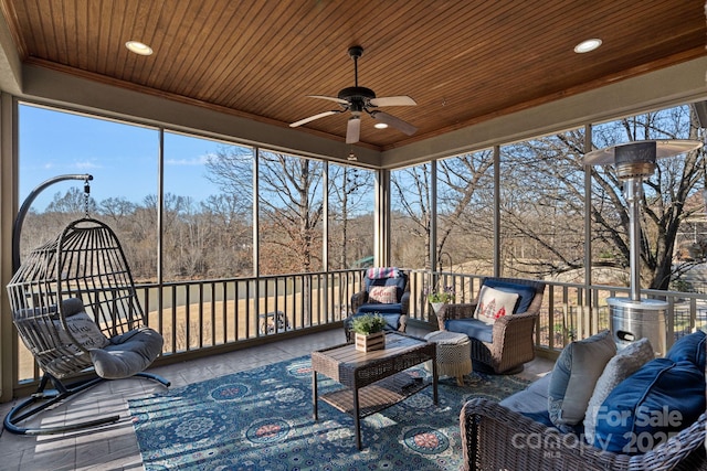 sunroom / solarium with ceiling fan and wood ceiling