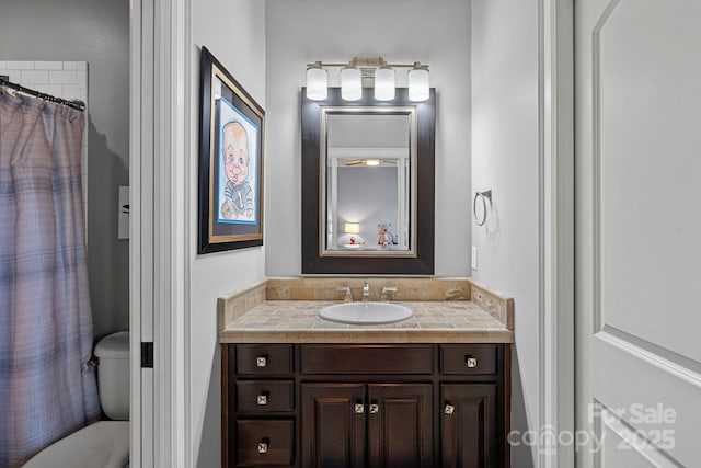 bathroom featuring vanity, toilet, and a shower with shower curtain