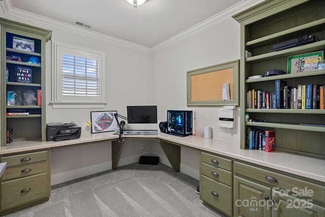 carpeted home office with crown molding and built in desk