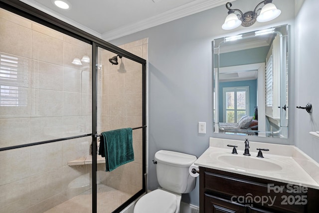 bathroom with ornamental molding, vanity, an enclosed shower, and toilet