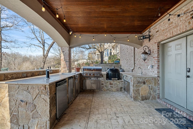 view of patio / terrace with area for grilling, a grill, and sink