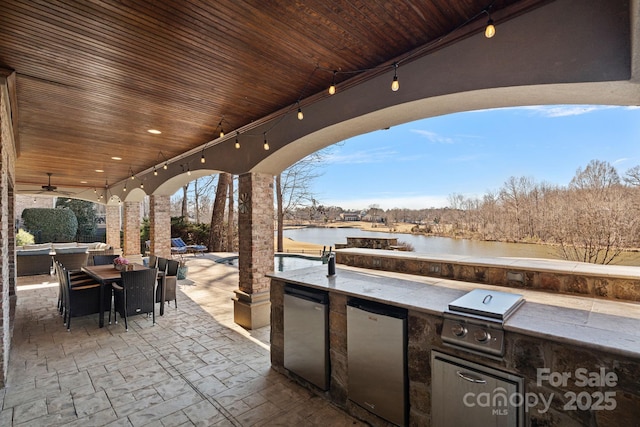 view of patio / terrace featuring a water view, area for grilling, outdoor lounge area, and ceiling fan