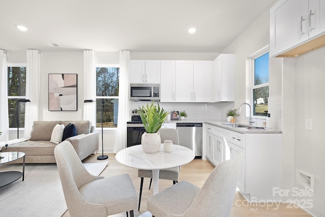 kitchen with white cabinetry, stainless steel appliances, and sink