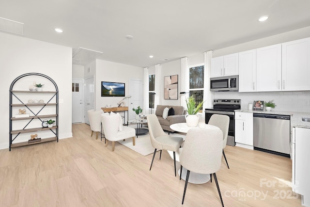 dining space featuring light hardwood / wood-style floors